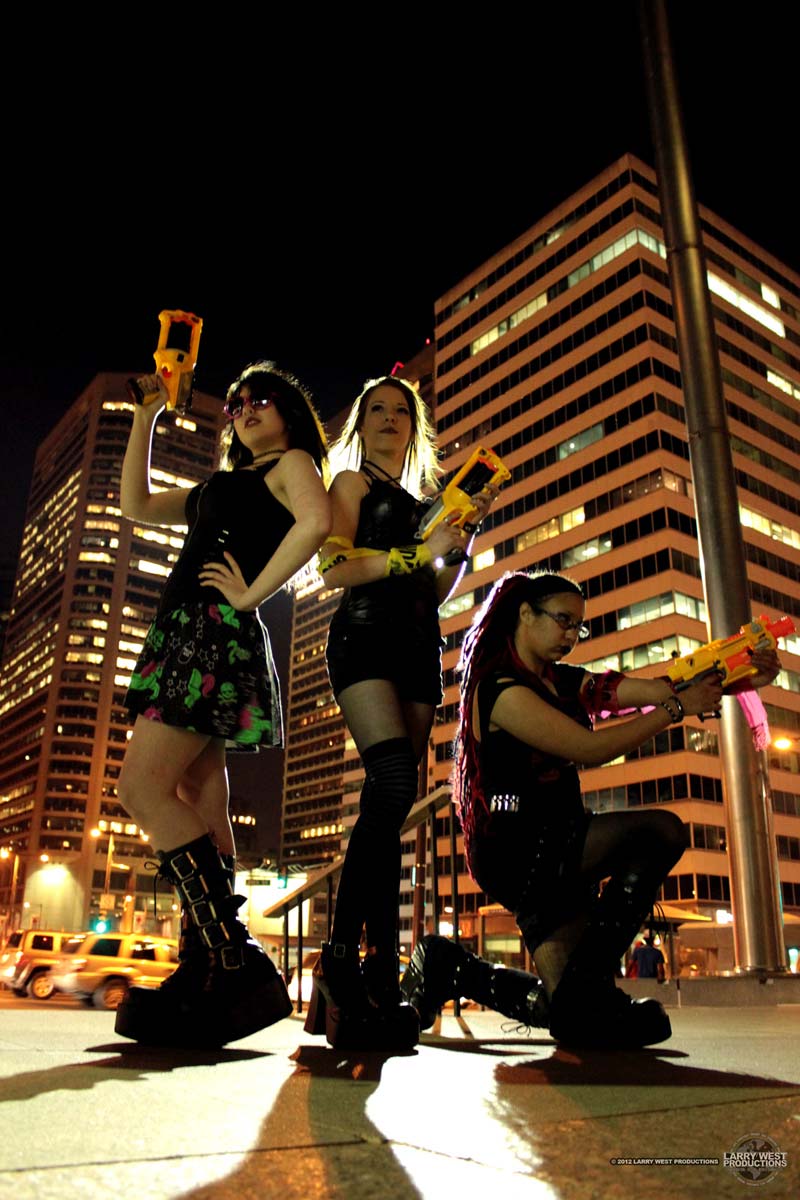 Women with Nerf Guns at night with a light behind them